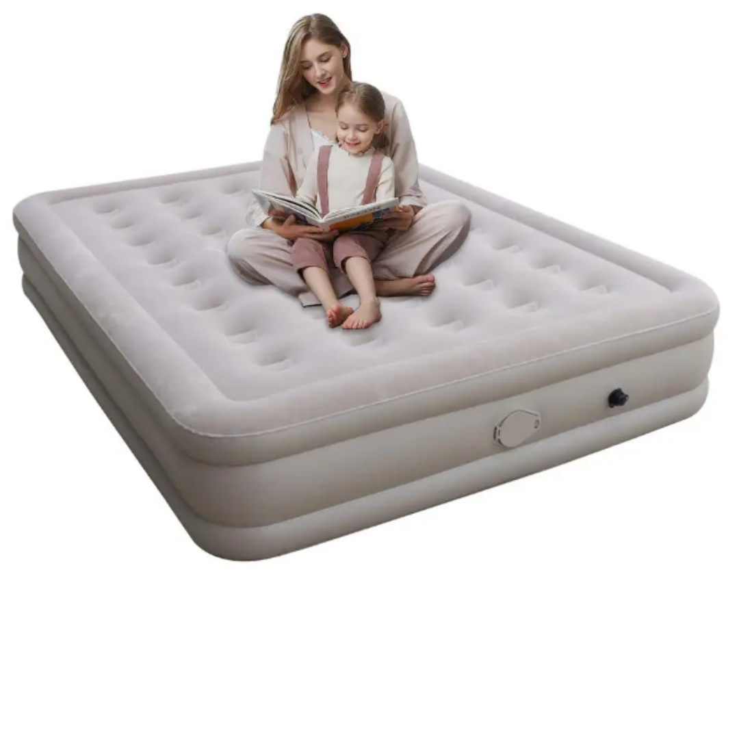 Woman and child sitting on an inflatable mattress reading a book.